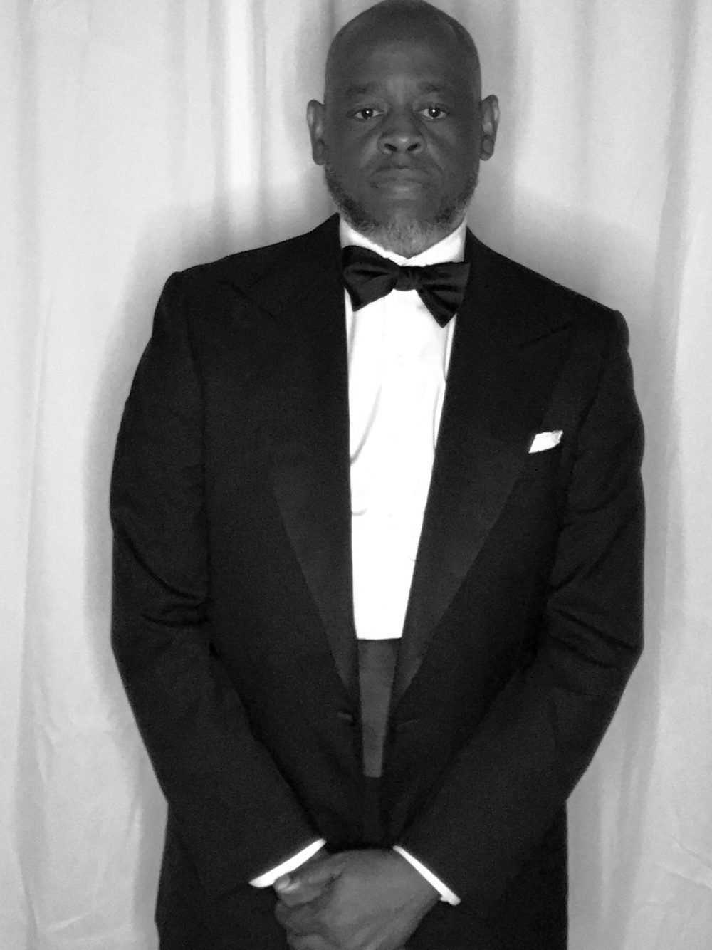 Vladimir Riche in a peak lapel dinner jacket, black bow tie and white pocket square.